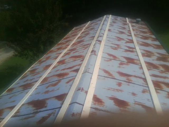 Rusted metal roof panels with new wood purlins before replacement — Storm Damage Roof Repair in South Dayton by Roofing Brothers