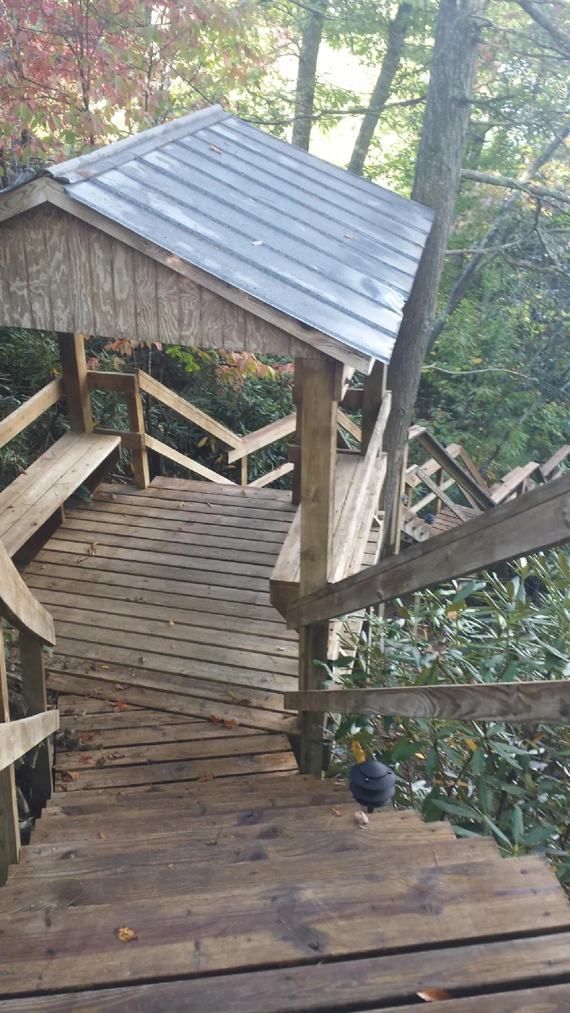 Metal roofed shelter over wooden steps on a wooded walkway — Skylight Repair & Installation work by our crew in South Dayton