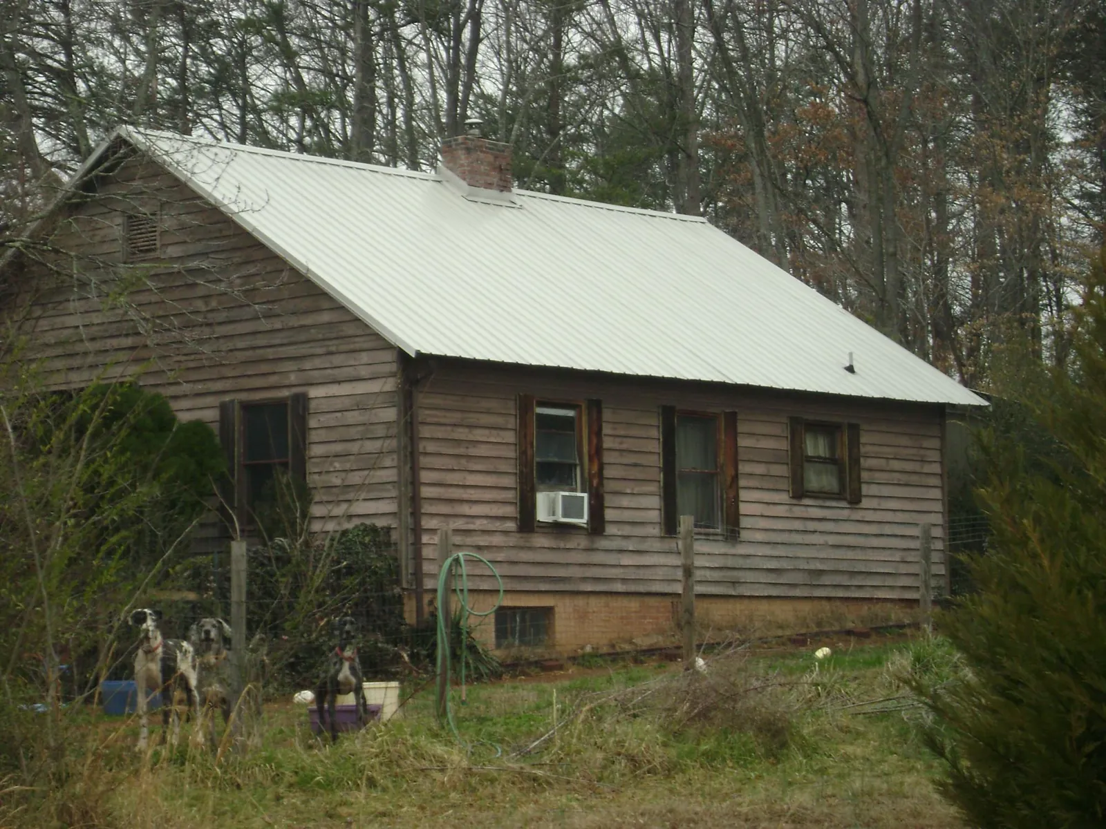 White metal roof on an old wood sided farmhouse, from a Metal Roof Installation job in South Dayton
